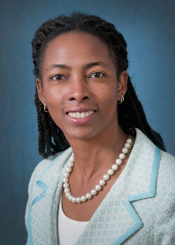Tochi Iroku-Malize, MD, wearing a blue suit